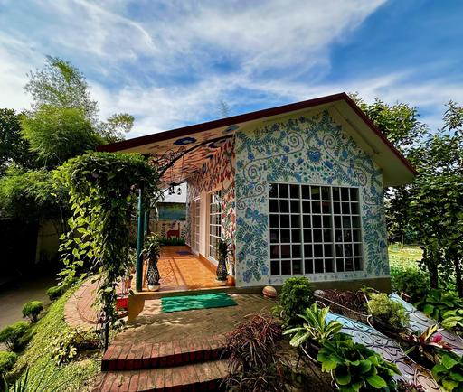 Charming library cottage at Barnochata, adorned with intricate mosaic art, set within the verdant grounds of a Dhaka hotel and resort in Savar.