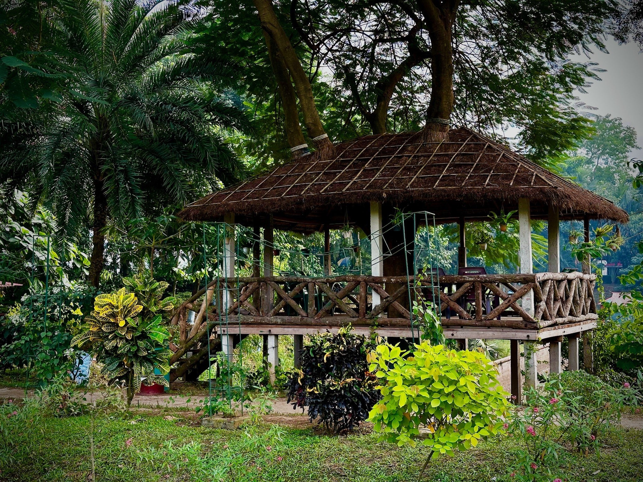 Charming wooden gazebo nestled in the lush gardens of Barnochata, a tranquil Dhaka hotel and resort located in Savar.
