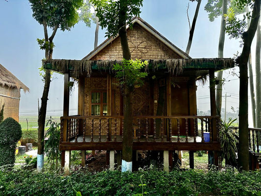 Elevated bamboo cottage at Barnochata, blending traditional architecture with the natural surroundings of a Dhaka hotel and resort in Savar.