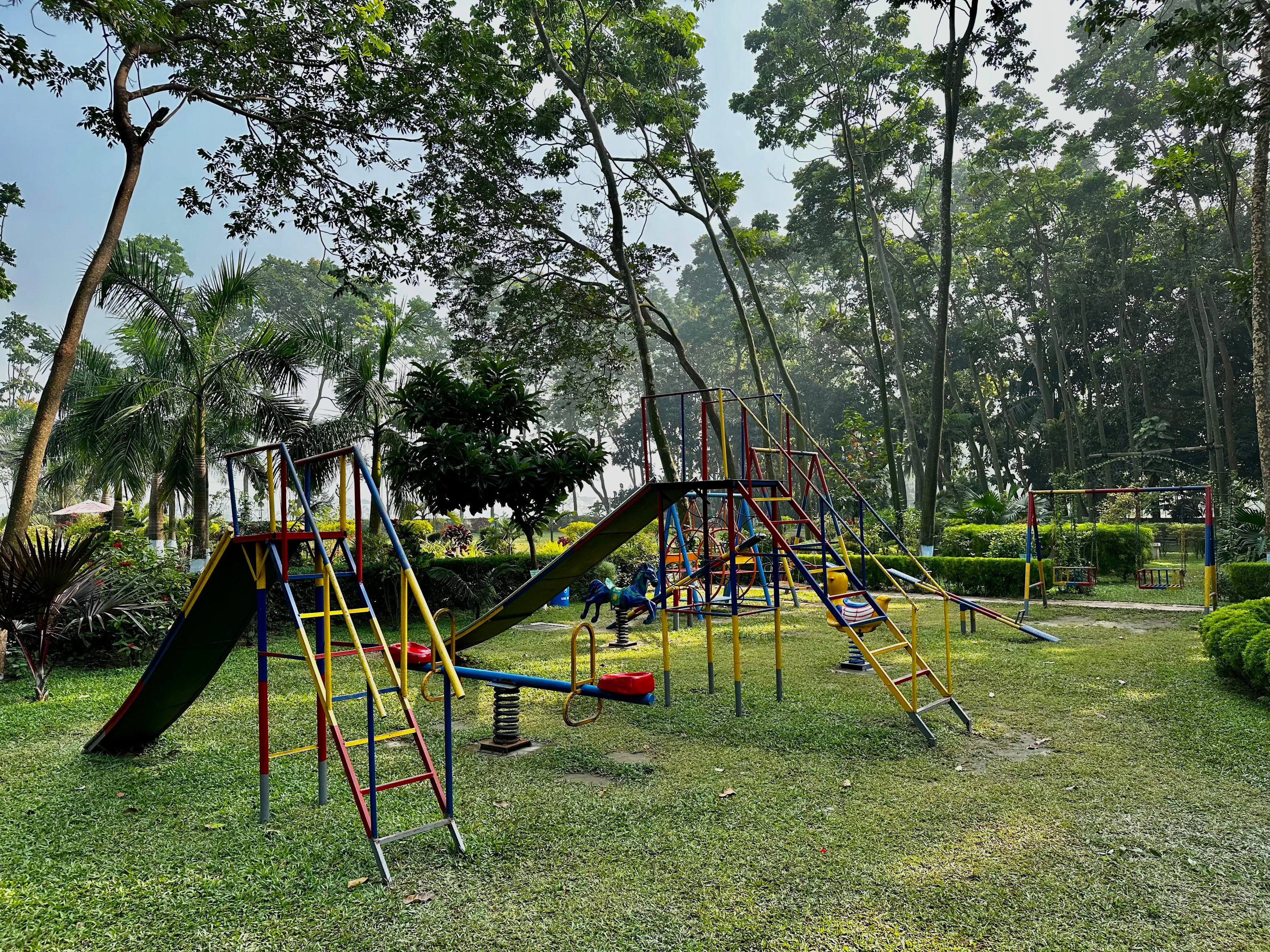 Children's playground set among the verdant gardens of Barnochata, a family-friendly resort and Dhaka hotel located in Savar.